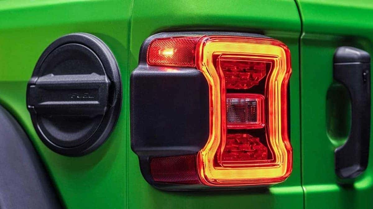 Close-up of a 2026 Jeep Wrangler taillight on a mojito-green exterior