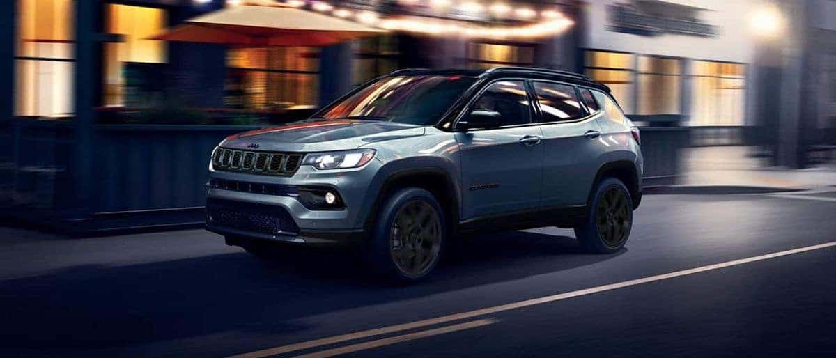 2026 Jeep Compass with blacked-out Altitude trim driving through a city at night
