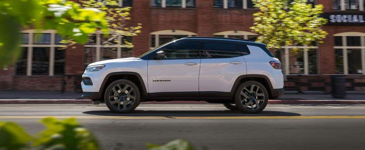 2026 Jeep Compass in white, side profile on a city street