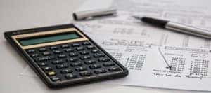 Black Calculator Near Ballpoint Pen on White Printed Paper