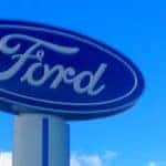 a ford logo on a sign in front of a blue sky