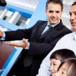 Family buying a car at the dealership