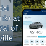 2025 Hyundai IONIQ 6 dashboard with smartphone showing Hyundai Bluelink+ app features