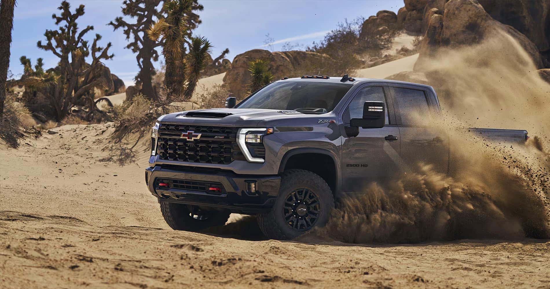 New Red Chevrolet Silverado 1500 pickup truck at Quirk Chevy dealership near Boston