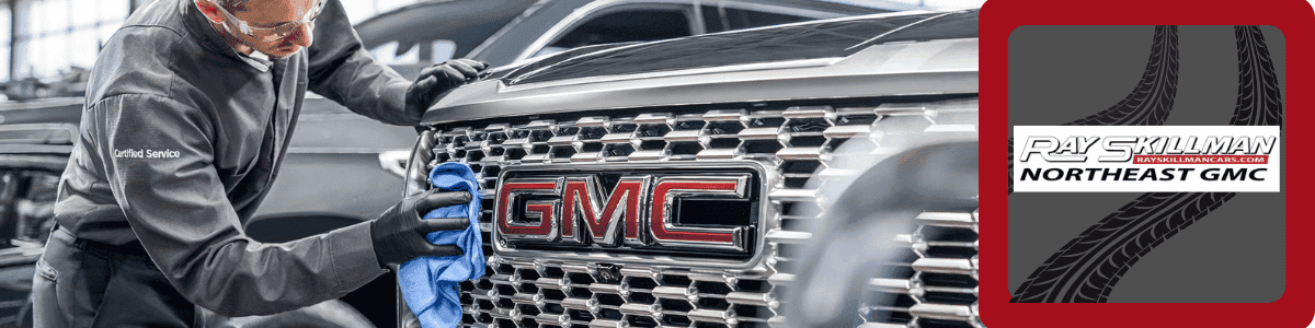 GMC Service Specials - GMC service technician cleaning grille of GMC vehicle