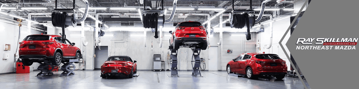 Mazda Service Center Fishers IN - banner image with 4 red Mazda vehicles in a service center