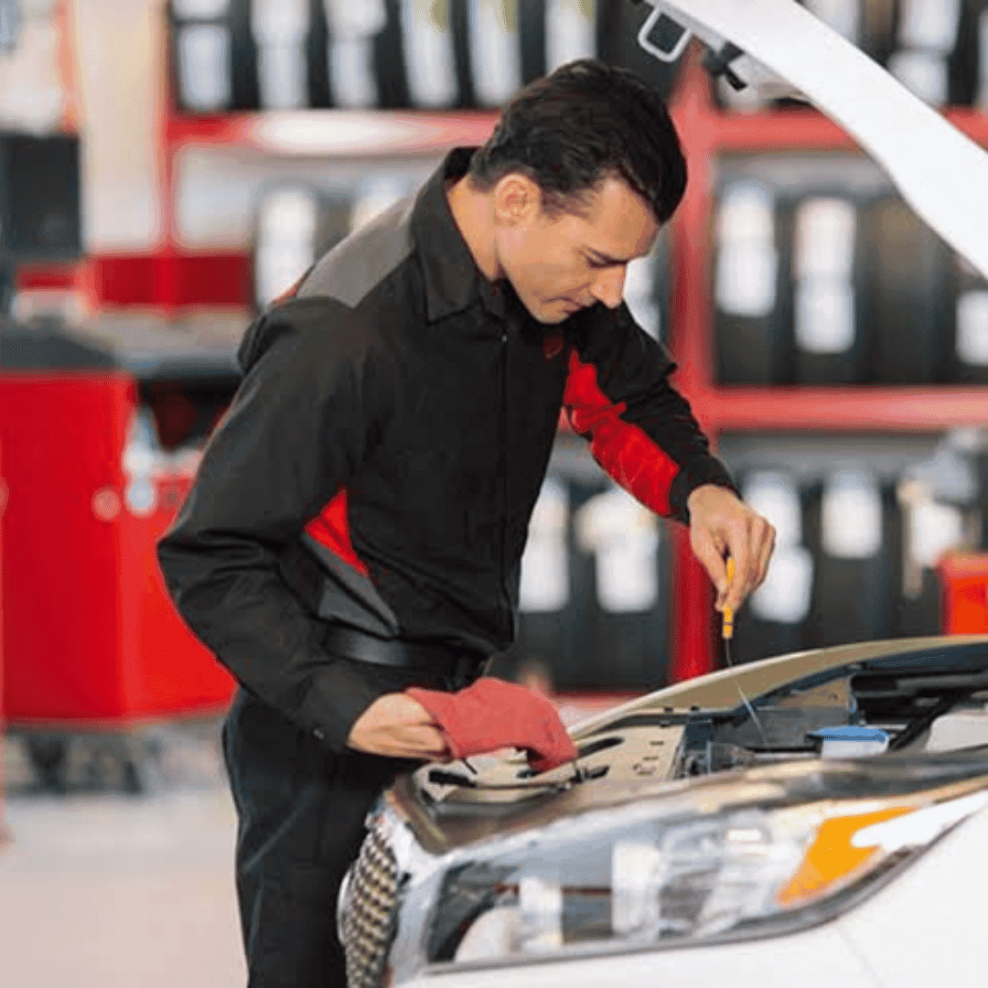 Kia oil change Southport, Indiana - a man pulling a dipstick out of a vehicle