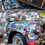 Old car covered in stickers