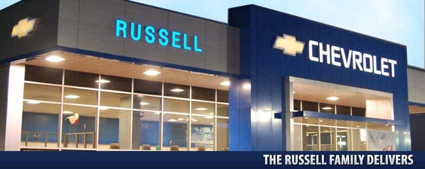 An exterior shot of a Chevrolet dealership at night.