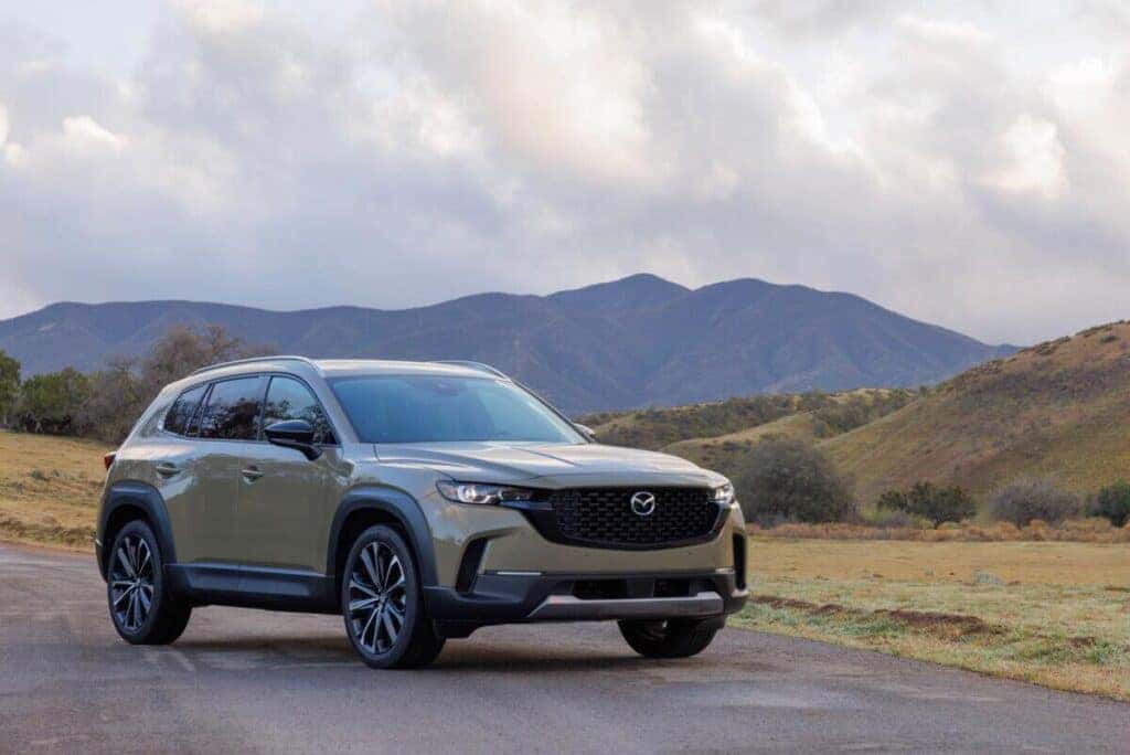 The 2025 Mazda CX-50 in front of rolling hills and an open sky