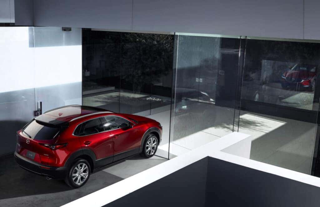 A mazda cx-5 parked in front of a modern minimalist building