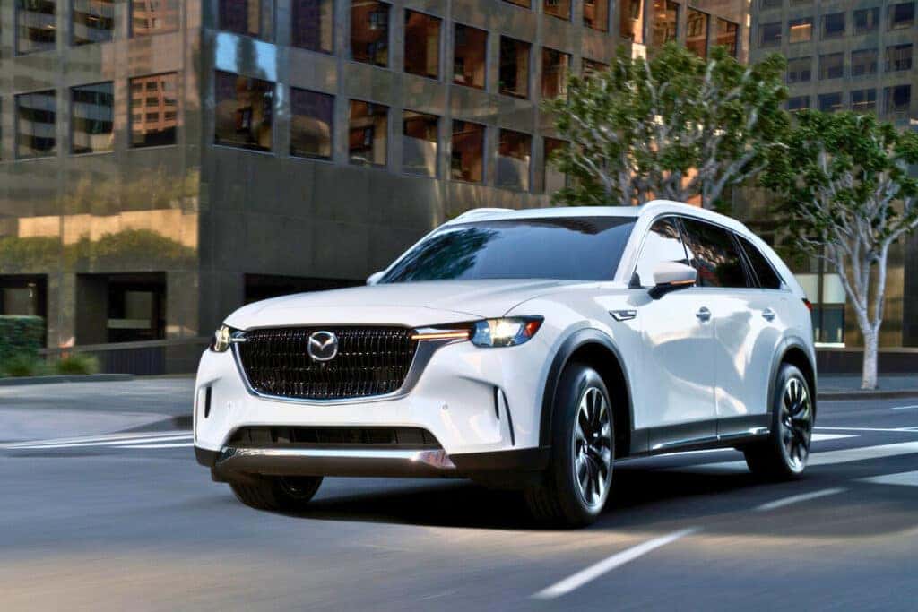 2025 Mazda CX-90 cruising down a busy city road