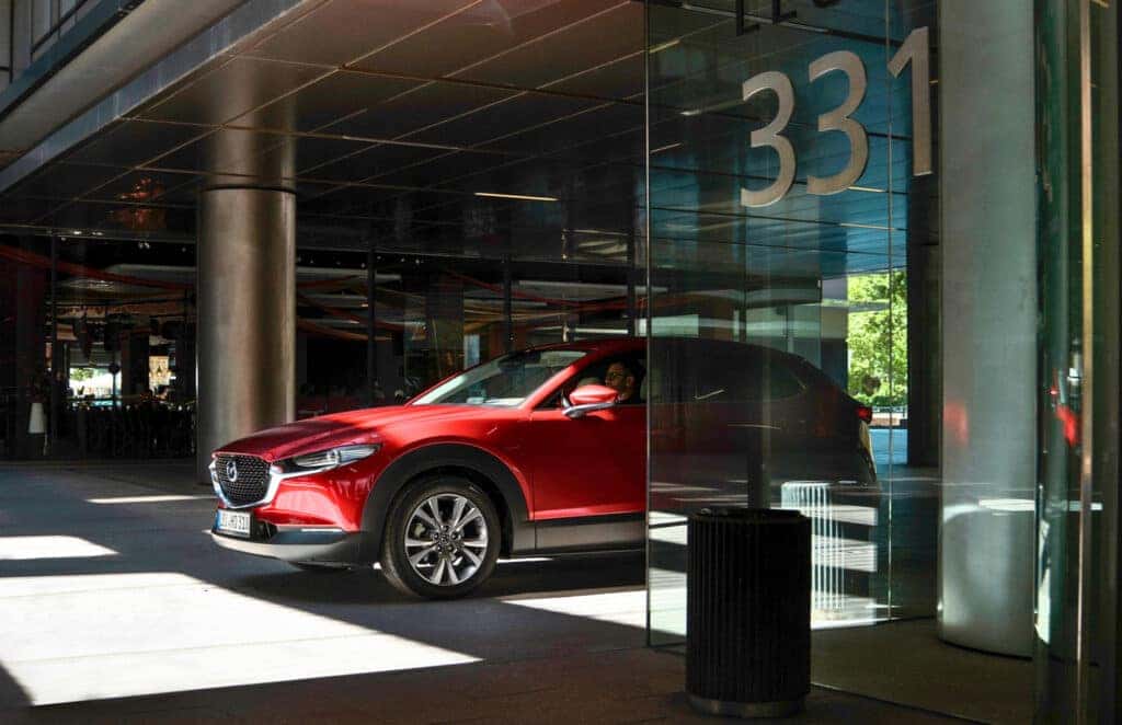 A sleek 2024 Mazda CX-30 SUV showcasing its stylish design, comfort, and practicality in a modern setting.