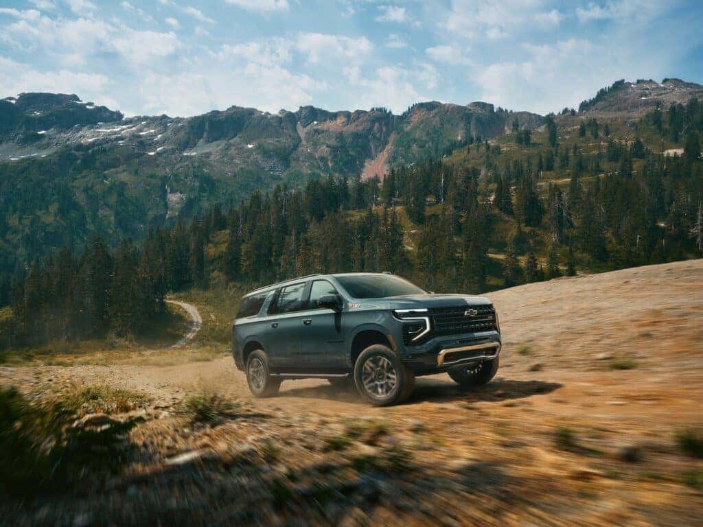 Front 3/4 angle in motion of 2025 Chevrolet Suburban Z71 in Cypress Gray.