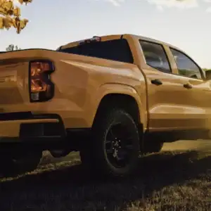 2026 Chevrolet Colorado WT Sunrise Orange parked on grass