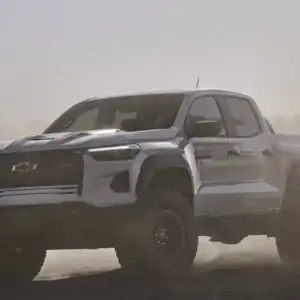 2026 Chevrolet Colorado ZR2 Summit White driving through dust