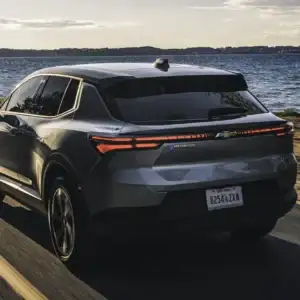 2026 Chevrolet Equinox EV LT 1 Sterling Gray Metallic driving past the ocean