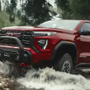 2026 GMC Canyon Volcanic Red Tintcoat driving through water