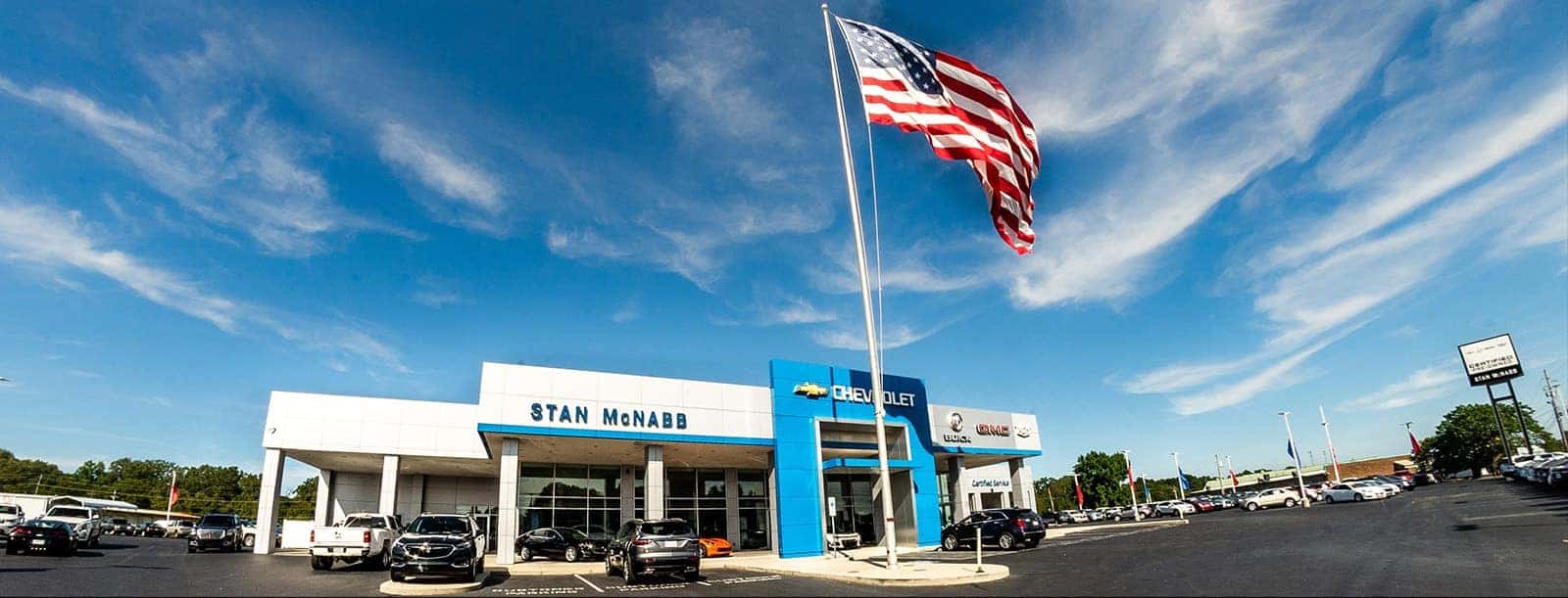 An exterior shot of a Chevrolet dealership at night.