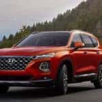 Lava Orange 2019 Hyundai Santa Fe driving on mountain road