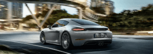 Rear view of a 2024 Porsche 718 driving
