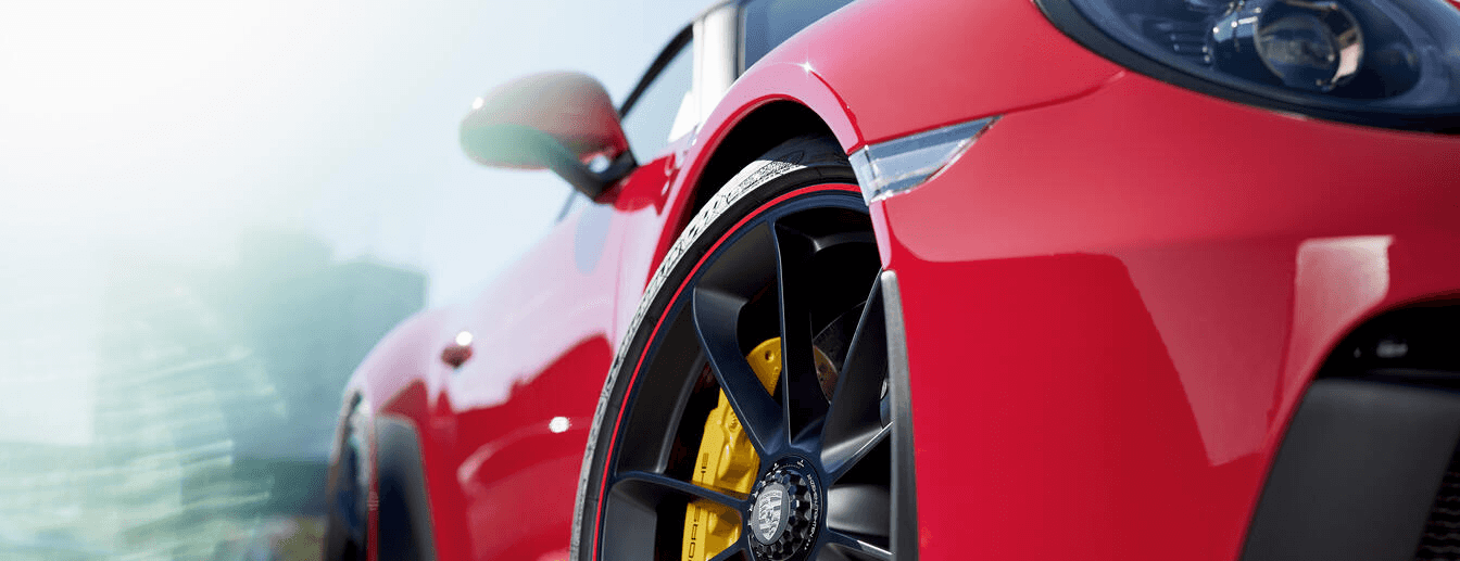 zoomed in picture of tires on a red porsche