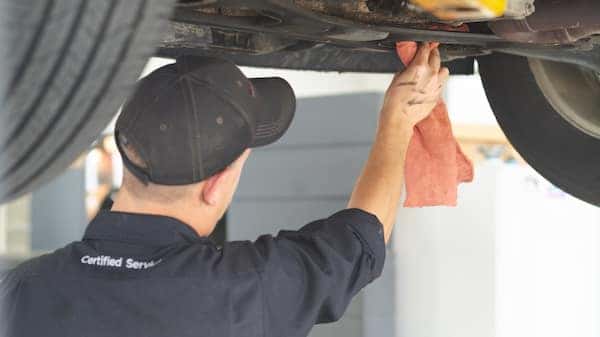 Service technician wipes down car