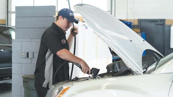 A service technician working on a car